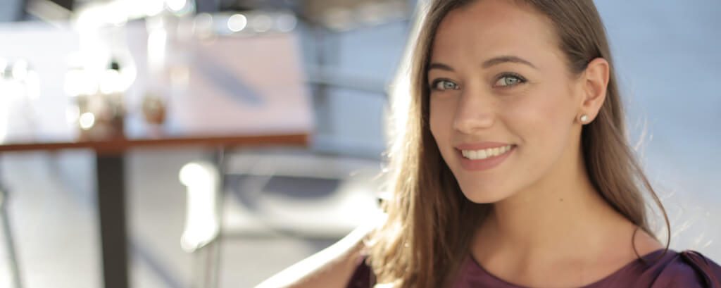 young woman smiling after periodontal care